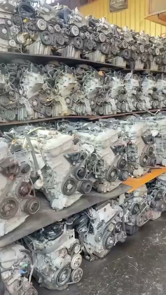 Shelves of used engines with their belts, pulleys and accessories still attached