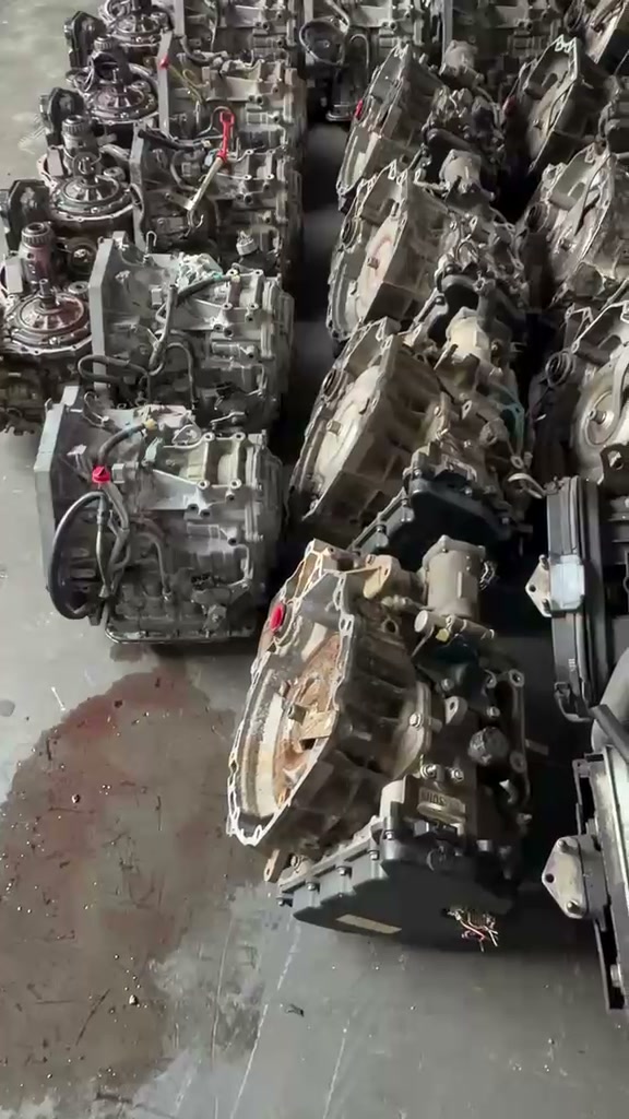 Used transmissions standing in rows on a concrete floor